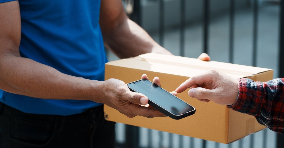 Entregador leva encomenda e recebe pagamento representando cash on delivery